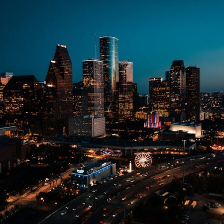 Stunning aerial view of downtown Houston's illuminated skyscrapers at dusk.