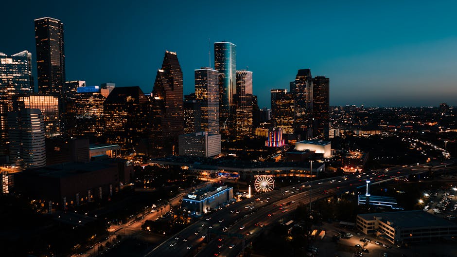 Stunning aerial view of downtown Houston's illuminated skyscrapers at dusk.