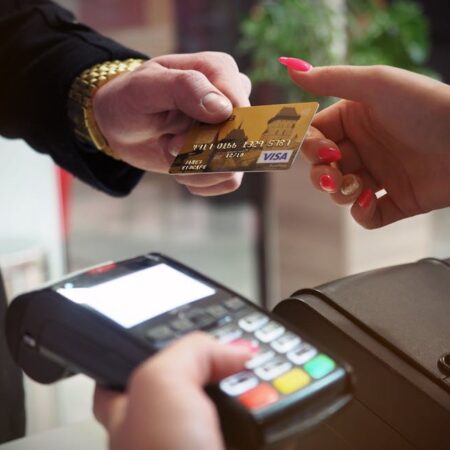 e-commerce website Close-up of a credit card payment being processed at a POS terminal.