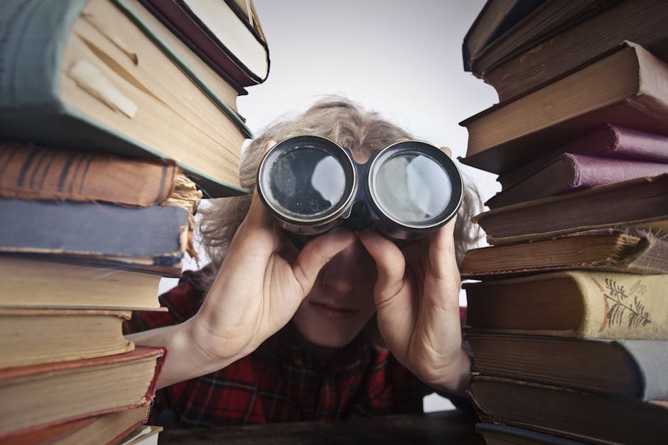 Blog | iGlobalWeb | Web Design SEO eCommerce Marketing Printing Company | pexels photo 3769697 3769697 A man observing through binoculars surrounded by stacks of vintage books indoors.
