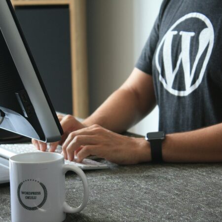 zk ydz2ias 450x450 | Home | iGlobalWeb person in black and white t-shirt using computer
